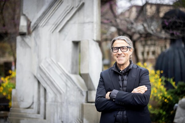 Richard Garber standing outside in front of concrete panel