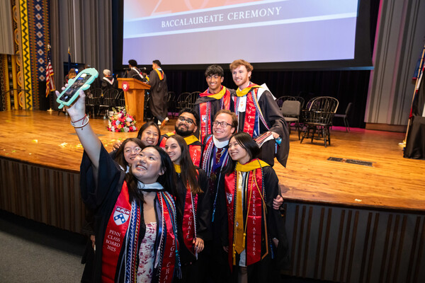 Students take a selfie at Penn’s Baccalaureate celebration in commencement regalia.
