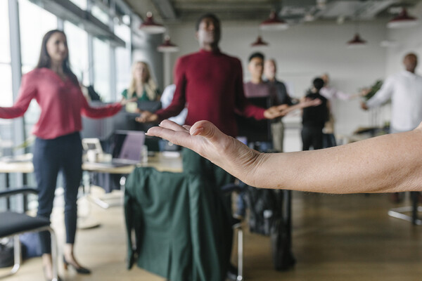 A splayed hand of a person doing breathing exercises at work.
