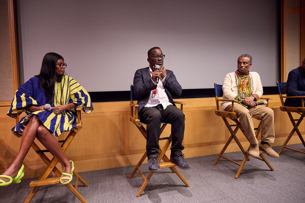 Sosena Solomon on stage during a Q&A at the Met with two other people.