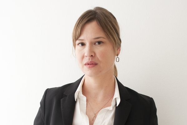 Portrait of a person in front of plain background.