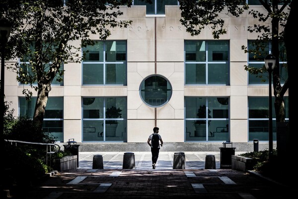 Annenberg School for Communication exterior and the silhouette of a student.