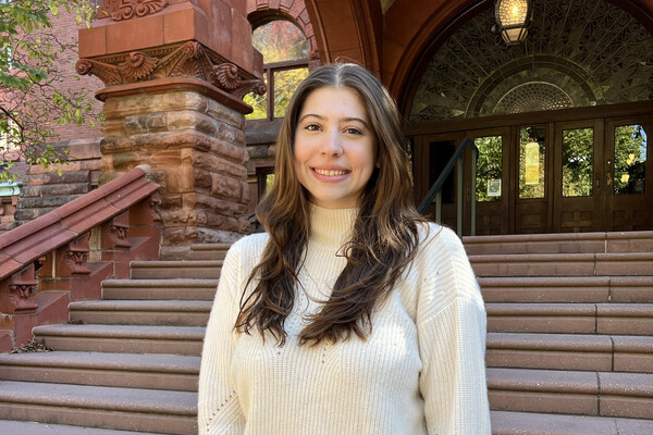 Sarah Usandivaras Klaehn standing outside steps of Fisher Fine Arts building on campus