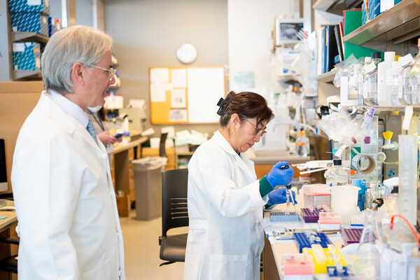 Two doctors in white lab coats in a lab.