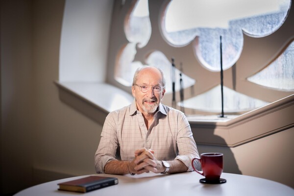 Benjamin Nathans sits at a table in his office.