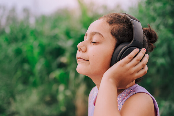 Young child with headphones on.