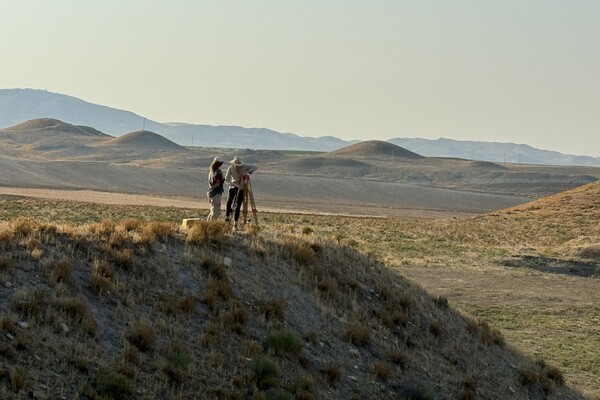 Studying the tumuli and what might rest beneath, researchers gather near the citadel of Gordion, Türkiye.