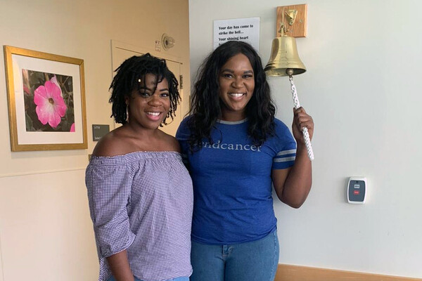 Bethany (left) and Brooklyn Olumba, Brooklyn is ringing the Penn Medicine bell.