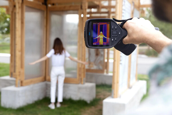 A heat scan being taken on a human under a cooling cover structure