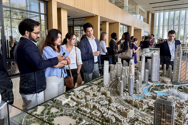 Lauder Institute students looking at a scale model of a city.