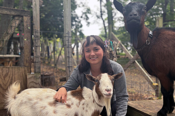 Grace Freund with a goat from the Philly Goat Project.