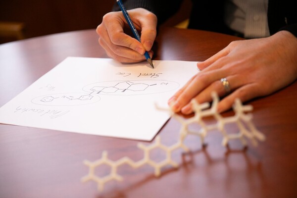 A researcher scribbles an organic molecule