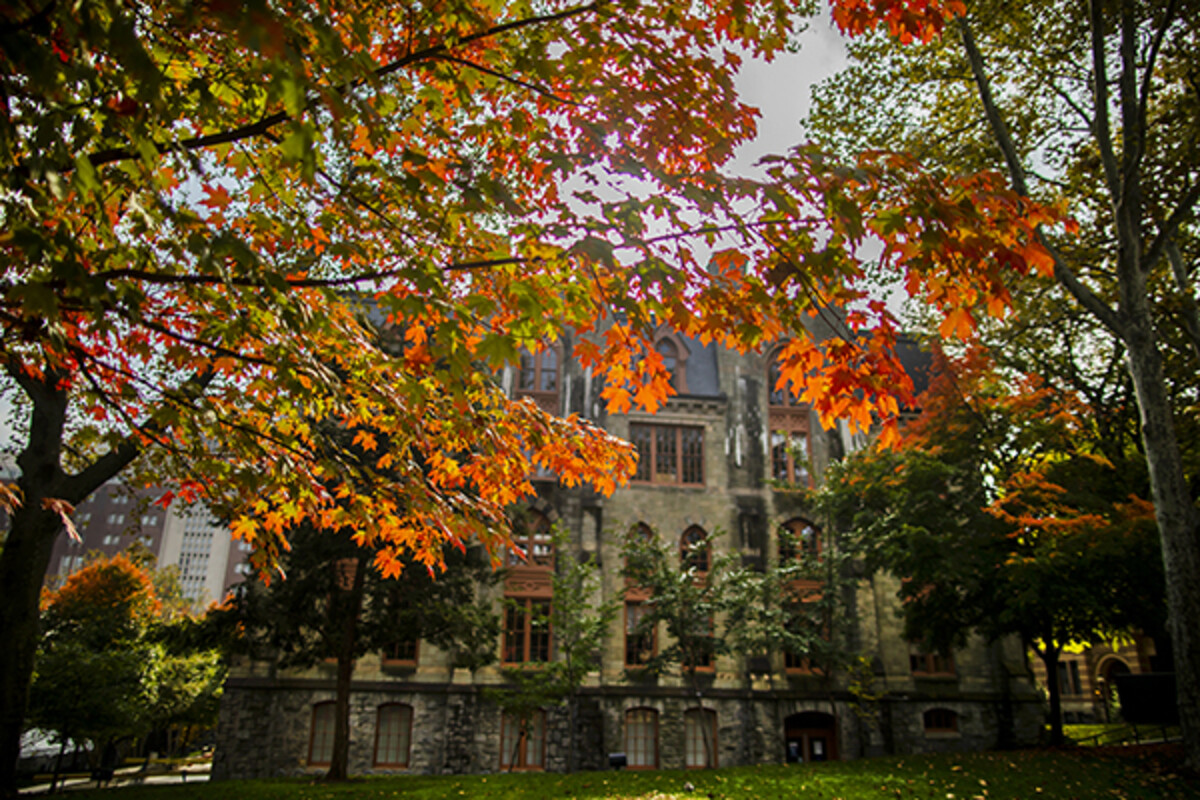 College Hall in daylight in autumn surrounded by fall foliage.