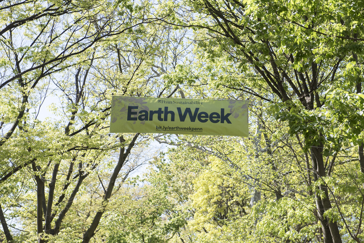 Earth Week banner between trees.