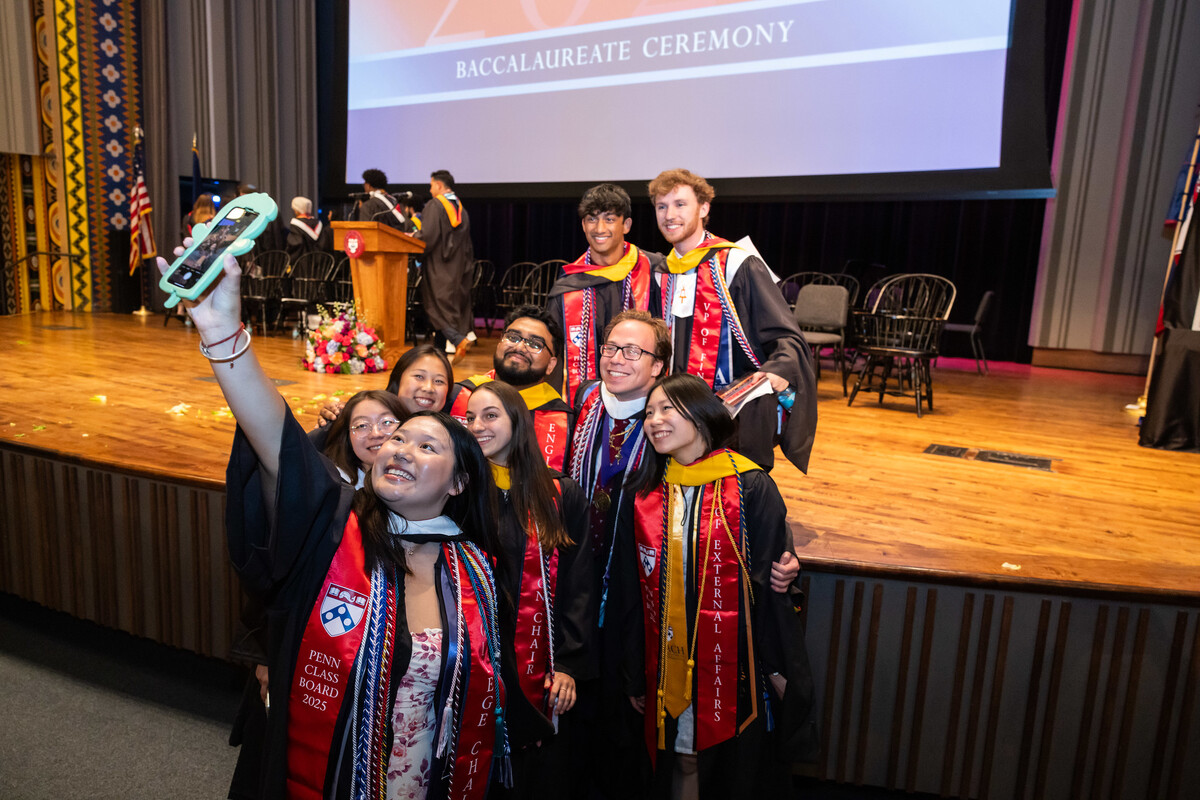 Students take a selfie at Penn’s Baccalaureate celebration in commencement regalia.