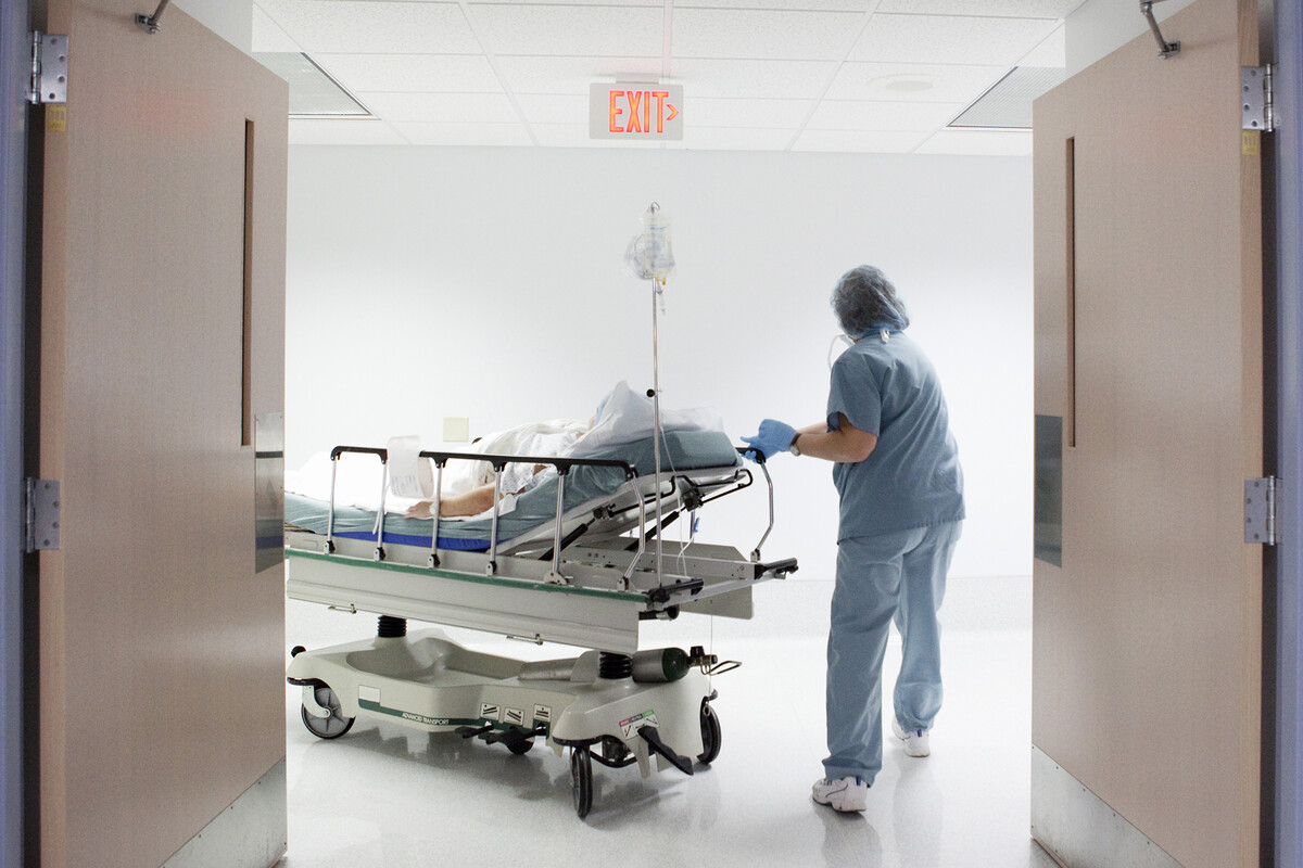 Nurse wheels patient to surgery.