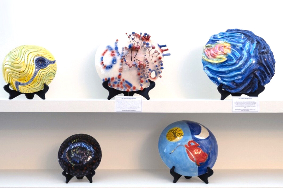 Five ceramic art pieces on display.