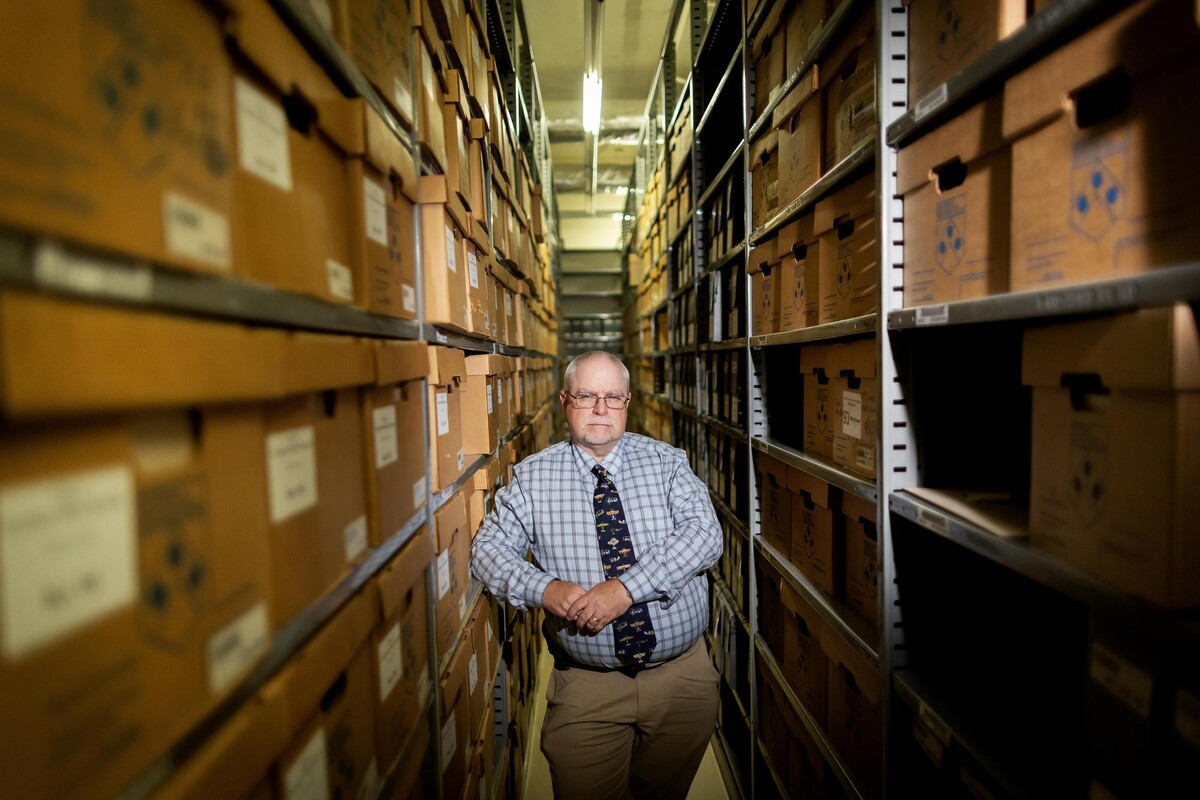 J.J. Ahern stands in a storage area in the University Archives.