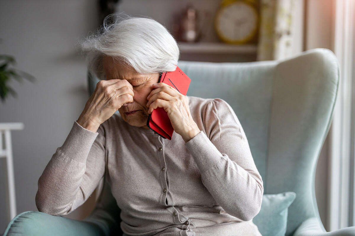 An elderly person on the phone.