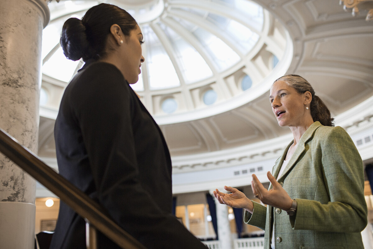 Two people speaking in a government building.