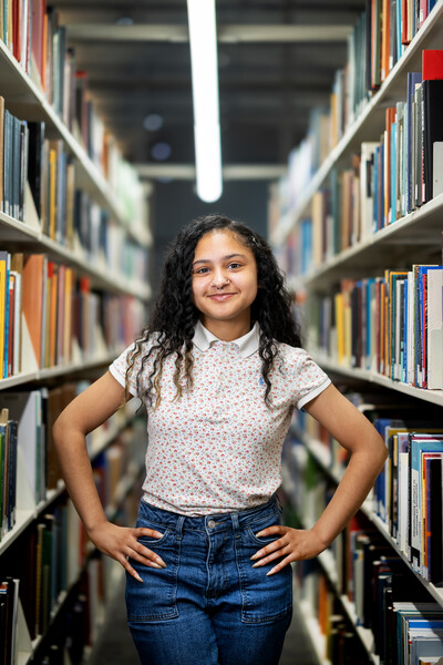 Sierra Williams standing in a library aisle