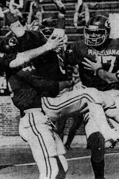 Martin Vaughn is all smiles and Adolph Bellizeare, held up by Ron Kellogg, kicks his heels after scoring a Penn touchdown at Franklin Field against Brown.